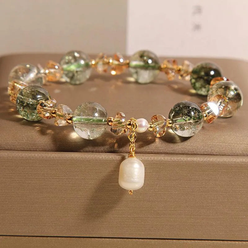 Adjustable green phantom quartz and champagne crystal bead bracelet on a string cord.