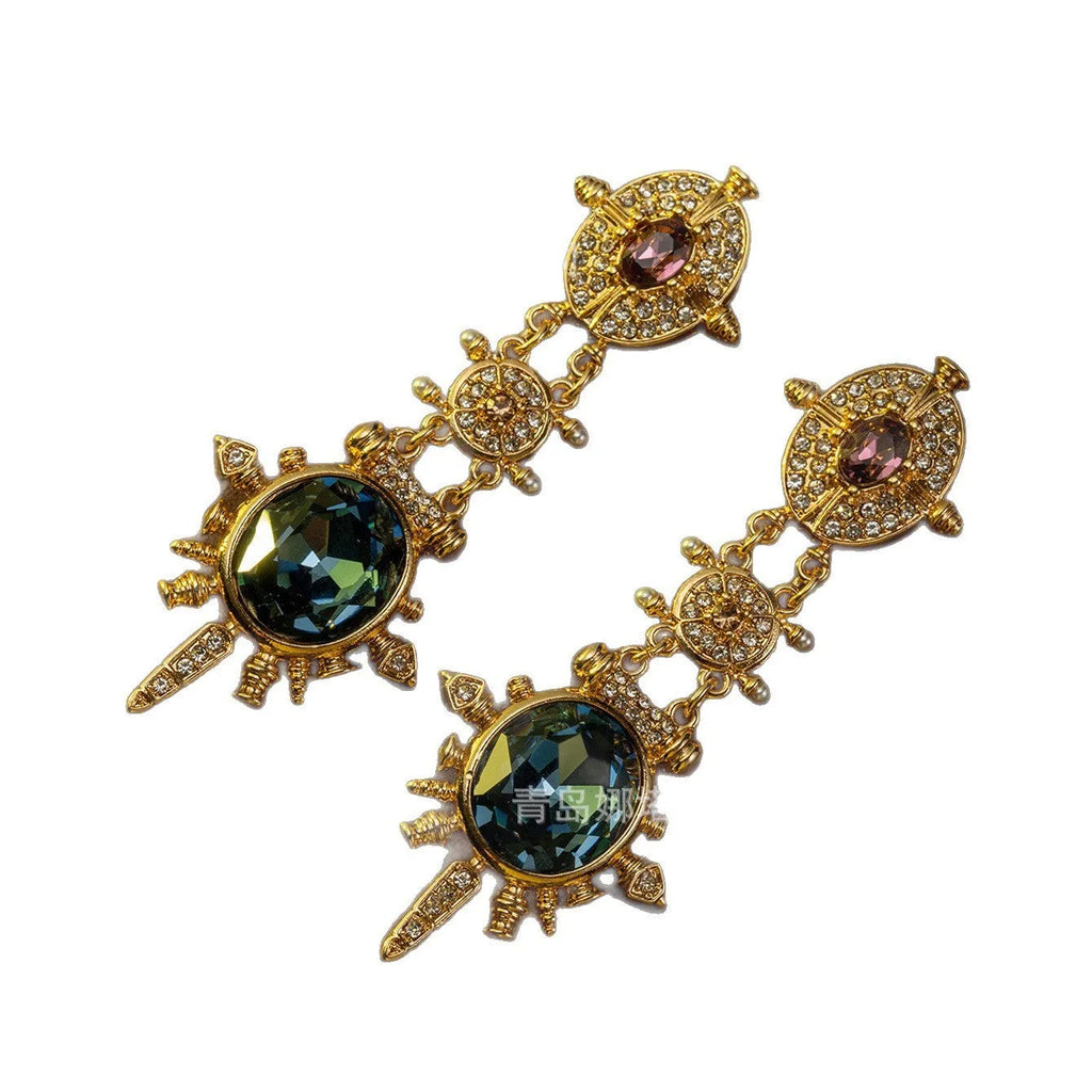 A pair of round geometric stud earrings with a gold finish and retro court style design.