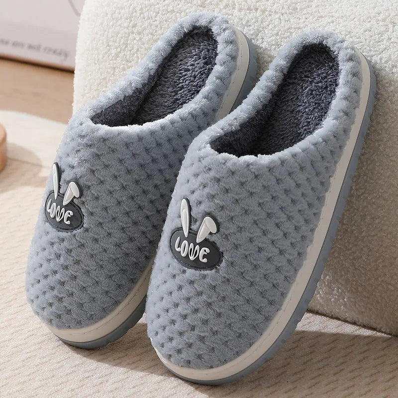 Women's rabbit plaid design winter slippers with artificial fur upper and thick rubber sole.
