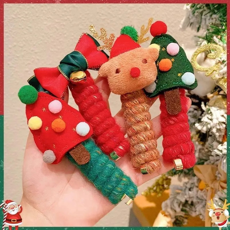 Children Christmas hair ties with red bell, green tree, khaki elk, and red tree designs on a light background