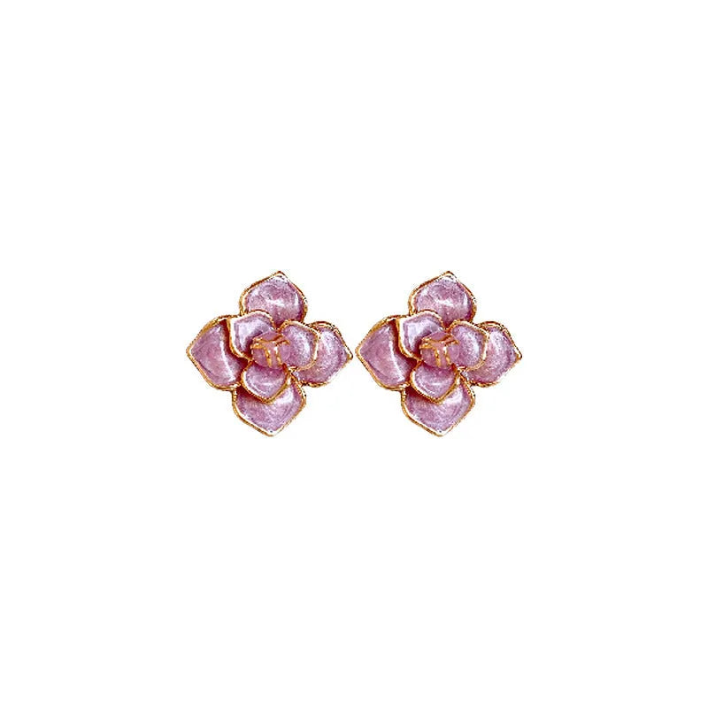 A pair of gold-plated purple oil-spot glaze flower stud earrings made from copper, showing detailed floral texture.