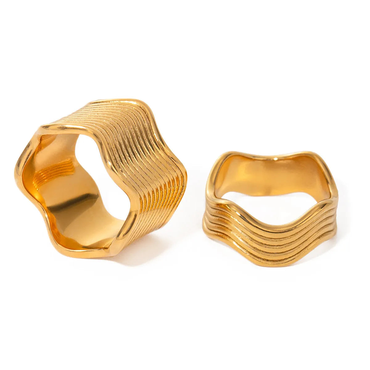 Stainless steel wide band wave ring in geometric Korean style on a plain background.