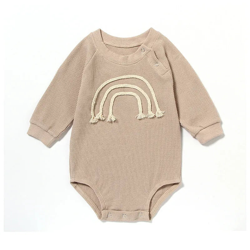 Baby wearing long sleeve waffle cotton romper with either cotton rope ties or button front closure in beige, khaki, green or blue