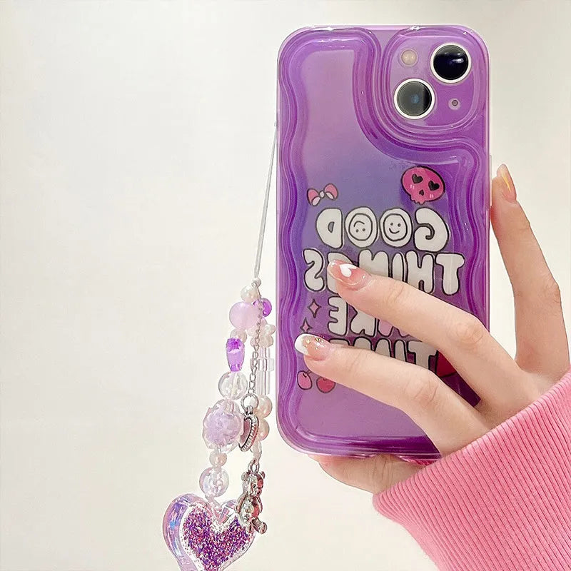 Purple graffiti love design iPhone 14 phone case with an attached silver chain bracelet.