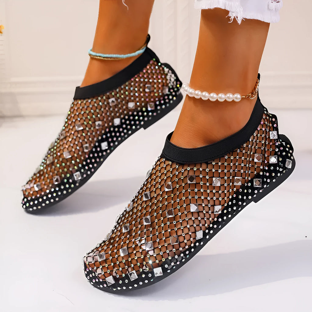 Women's white and colourful mesh flat sandals with rhinestone decoration and a round toe.
