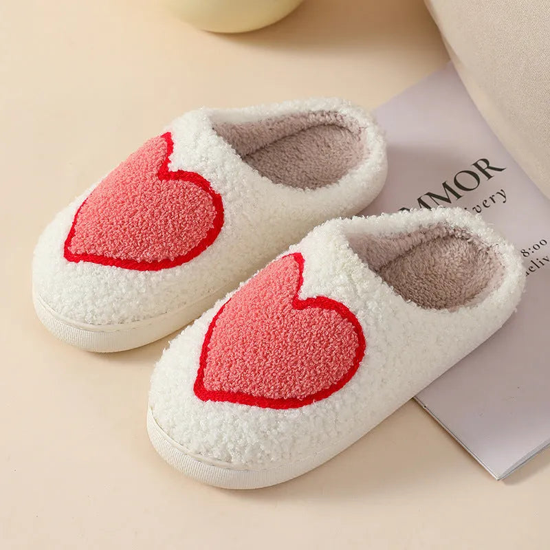 Women's plush cartoon love style slippers with a PVC sole in multiple colour options.