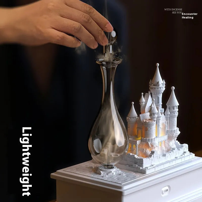 White medieval castle-shaped waterless aromatherapy diffuser with ambient light on a table.