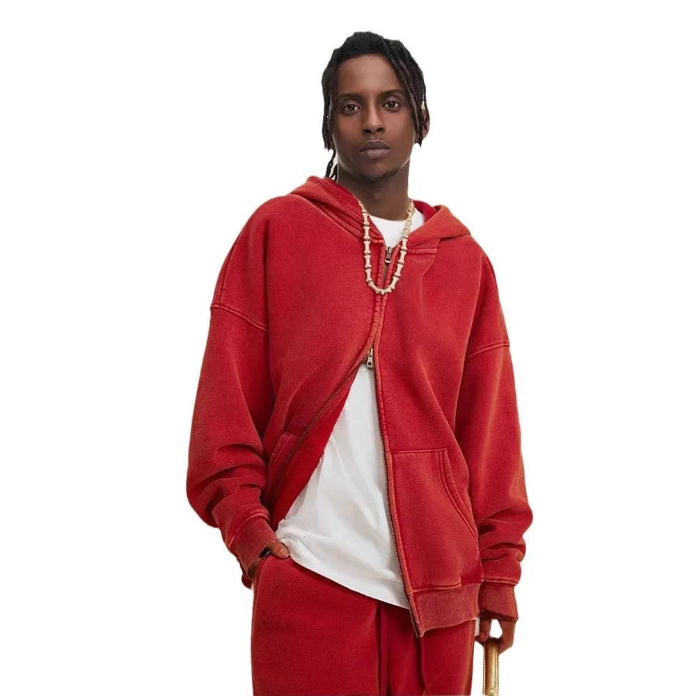 Man wearing a washed black cotton fleece-lined hooded cardigan with a double zipper front.