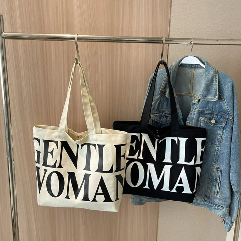 Large capacity canvas tote bag with letter print and upgraded zipper, off-white colour, on plain background