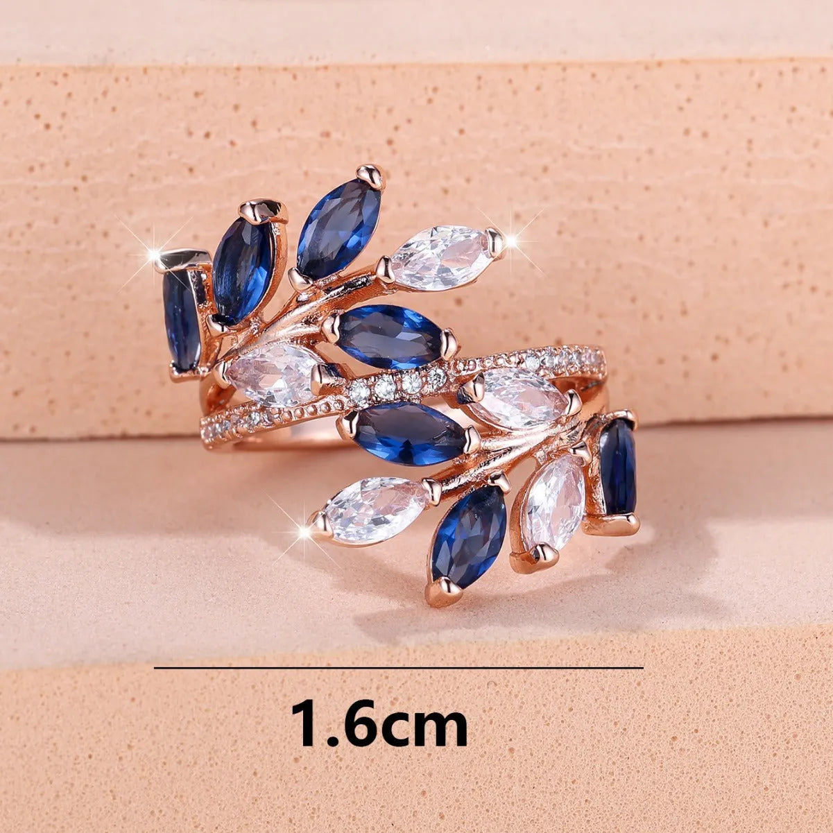 Adjustable copper leaf fashion ring with a central zircon stone on a model's hand, showing rose gold and platinum colour variants.