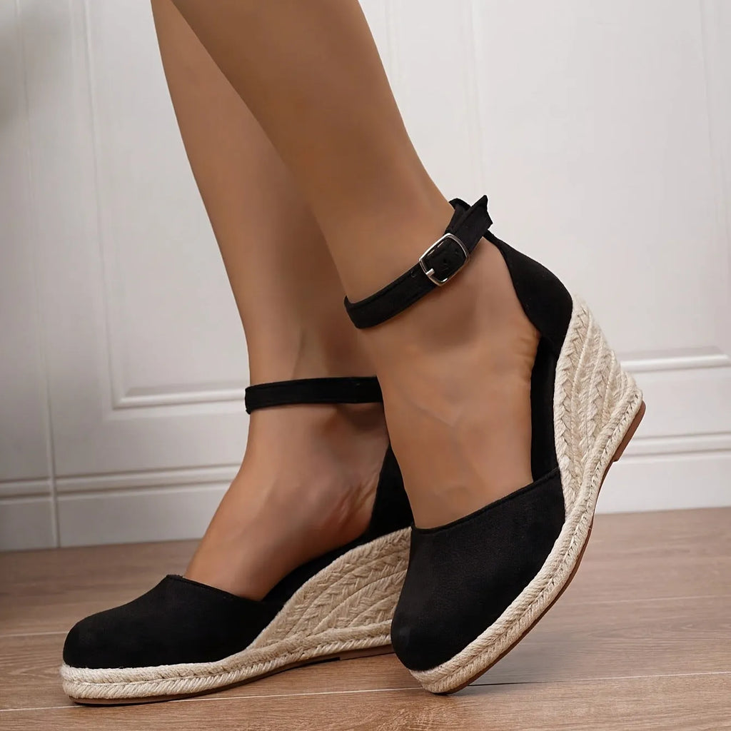 Women's apricot and black canvas wedge sandals with suede upper and buckle strap.