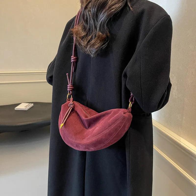 Soft PU crossbody underarm dumpling bag in black with visible sewing line detail