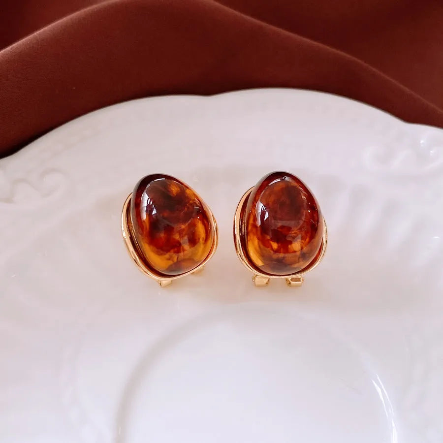 Amber water drop ear studs and ear clips in coffee colour with silver needles and electroplated resin drop shape