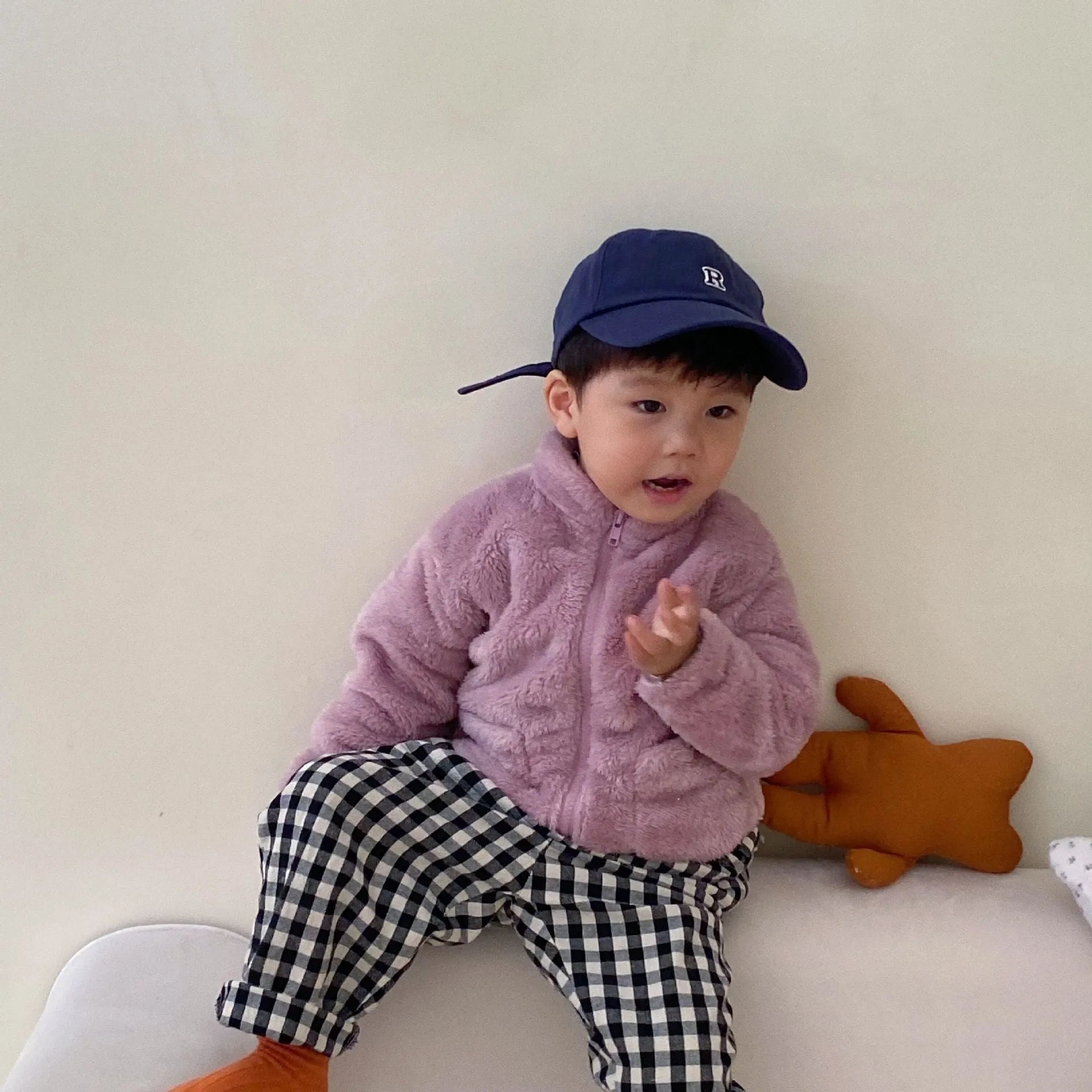 Blue children's sherpa fleece jacket with full zip, high collar, and front pockets.