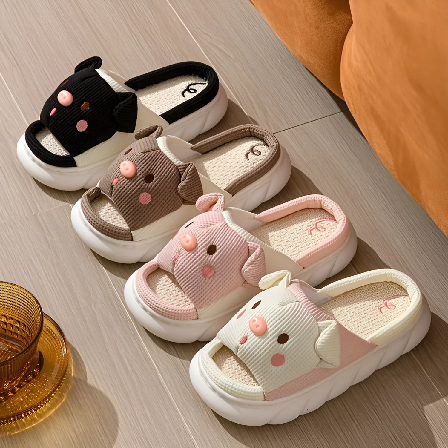 A pair of open-toe linen flip flop slippers for couples, shown in a choice of colours with a cushioned footbed.