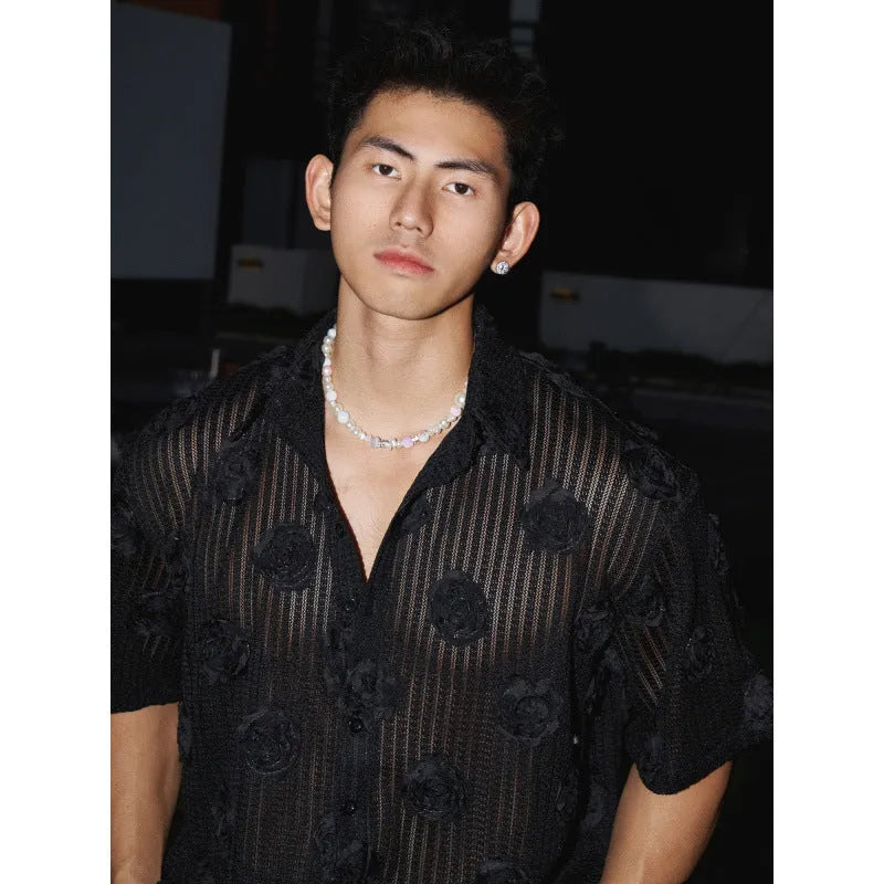 Man's loose-fit short-sleeve shirt with a white and black three-dimensional floral print on heavyweight fabric.