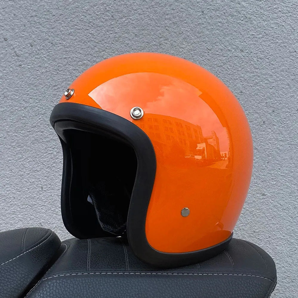 Retro-style open-face motorcycle helmet in matte black with floral design, showing clear visor and interior padding.