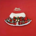 Red festive pet scarf with bell pattern draped on a dog, showing the cloak-style design for winter and holiday use.