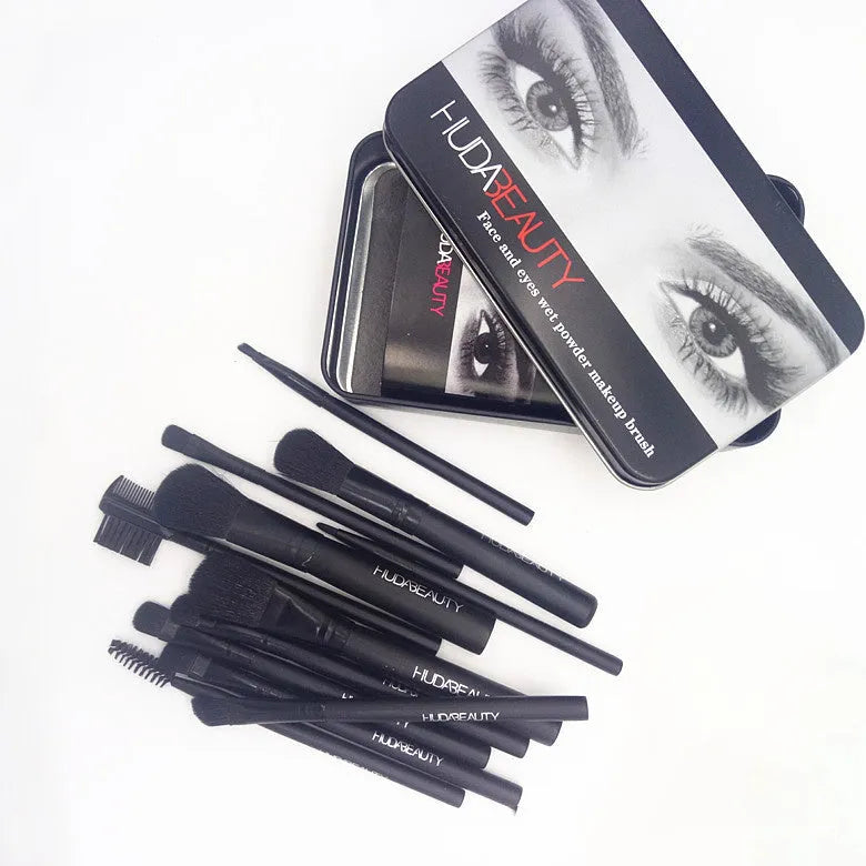 12 black makeup brushes in a tin box with nylon bristles and wooden handles on a white background