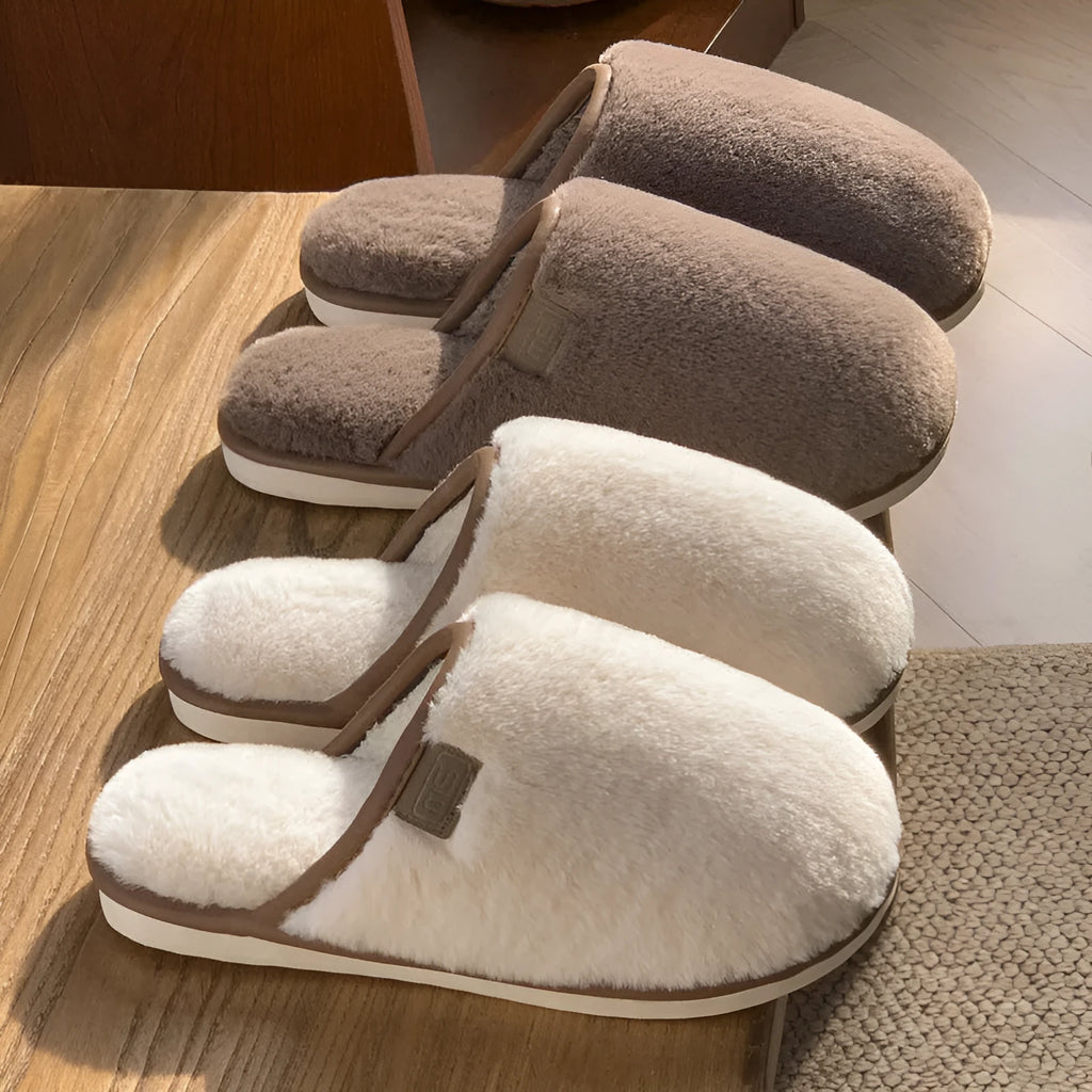 Pair of solid-colour plush house slippers with car stitching detail on the PVC upper.