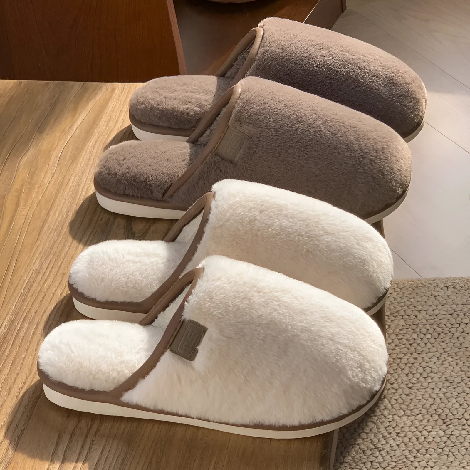 Pair of solid-colour plush house slippers with car stitching detail on the PVC upper.