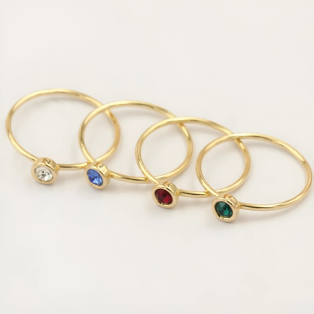 Women's copper knuckle ring with 14K gilding and zircon stones in green, blue, dark red, or white.