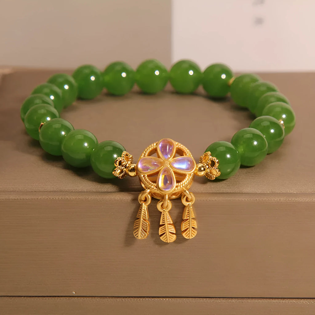 Green jasper crystal four-leaf clover dream catcher pendant on an adjustable women's bracelet.