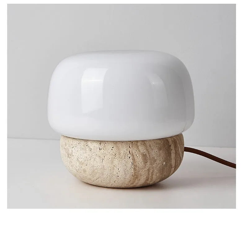 Cream-coloured retro glass bedside lamp with a button switch on its base.