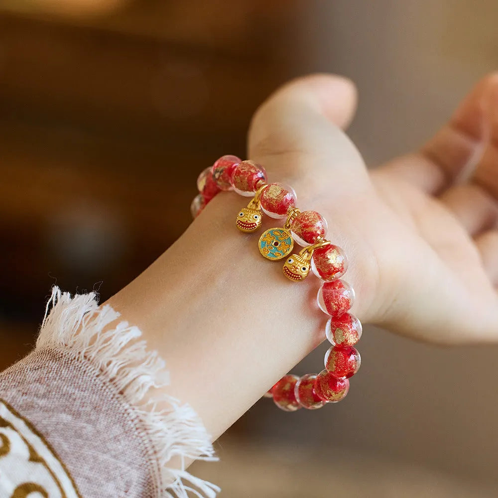 Handmade national style bracelet with gold foil coloured glaze swallowing gold beast charm
