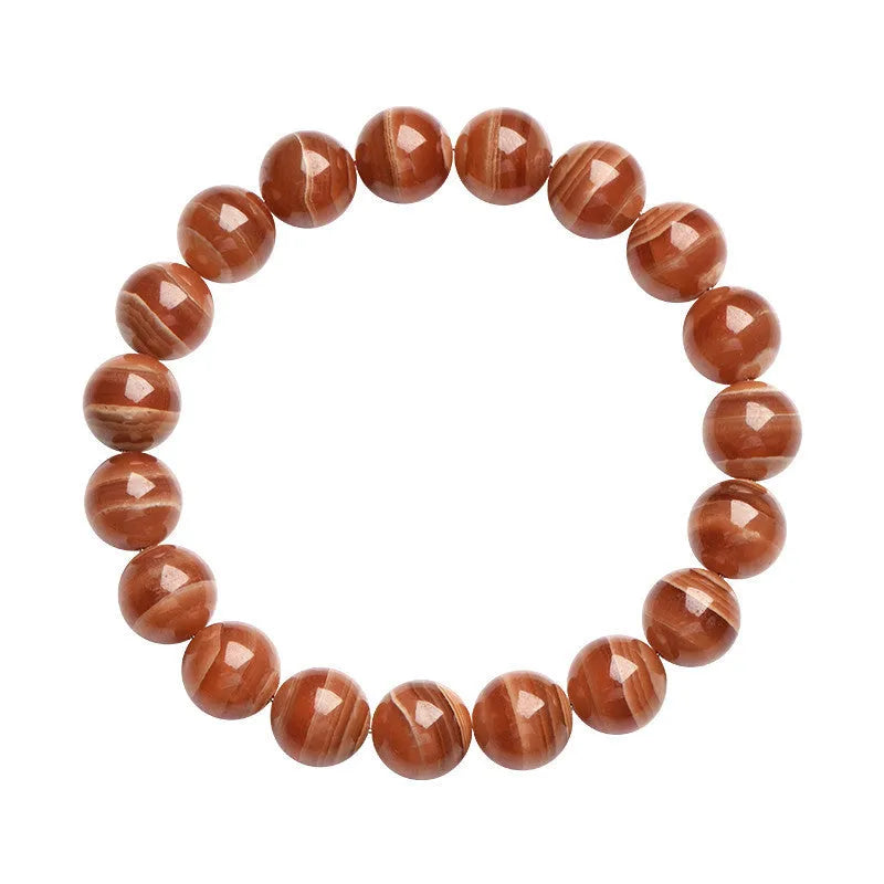 Natural Old Mine Rhodochrosite round bead bracelet on wrist, showing manganese spar colour.