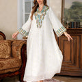 White long sleeve Arabic robe abaya on a hanger, full-length polyester maxi dress.