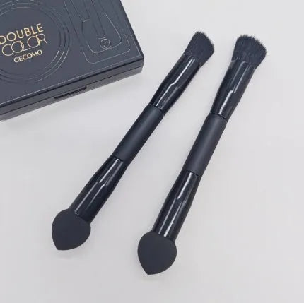 Elegant black double-headed makeup brush with a synthetic fibre brush and a miter sponge on a wooden handle.
