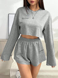 Grey women's long-sleeved T-shirt and matching shorts polyester suit set laid flat.