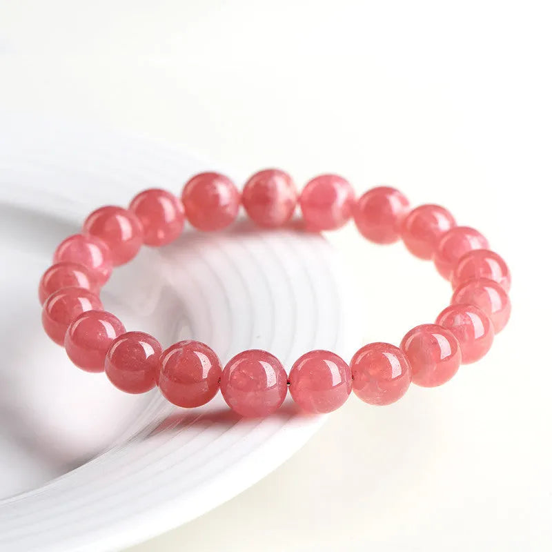 Women's geometric crystal bracelet with a Longevity Lock and red rhodochrosite stone beads.