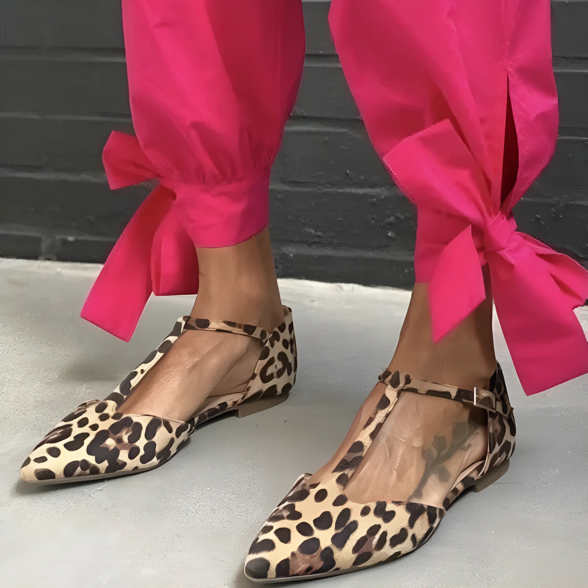 Leopard print women's pumps with pointed toe, cross shoulder straps, and a short chunky low heel.