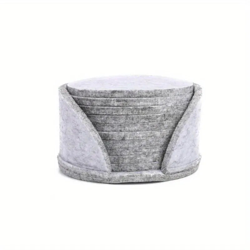 10 round felt coasters in black, brown, dark gray, and light gray arranged on a dining table