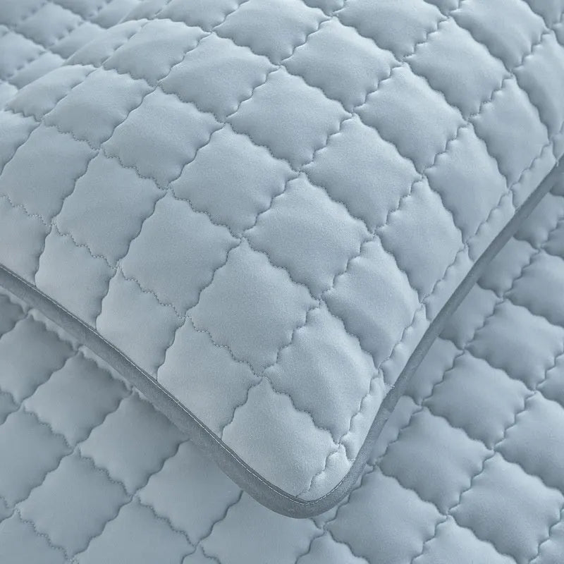 Class A waterproof washed cotton fitted sheet in blue on a bed.