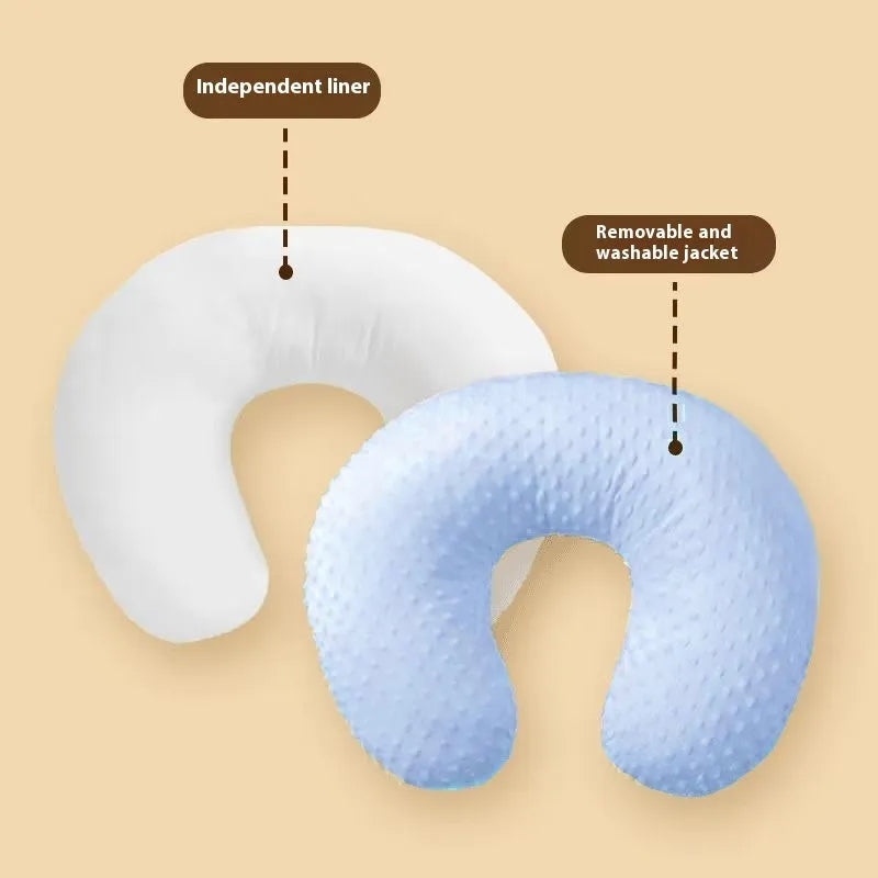Grey nursing pillow for breastfeeding with removable cover on a neutral background