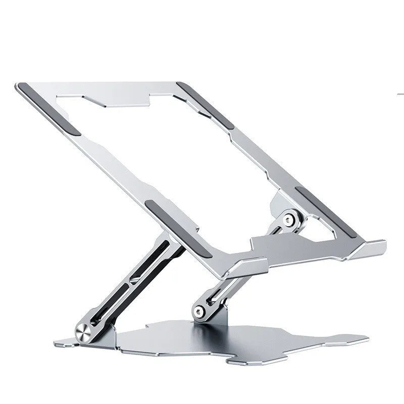 Grey aluminium laptop stand in a folded position next to an open laptop, showing its adjustable angle and hollow design.
