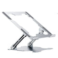 Grey aluminium laptop stand in a folded position next to an open laptop, showing its adjustable angle and hollow design.