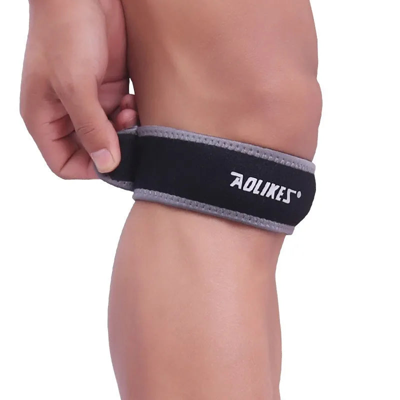 Black and grey patella retinaculum knee support for running and sports.