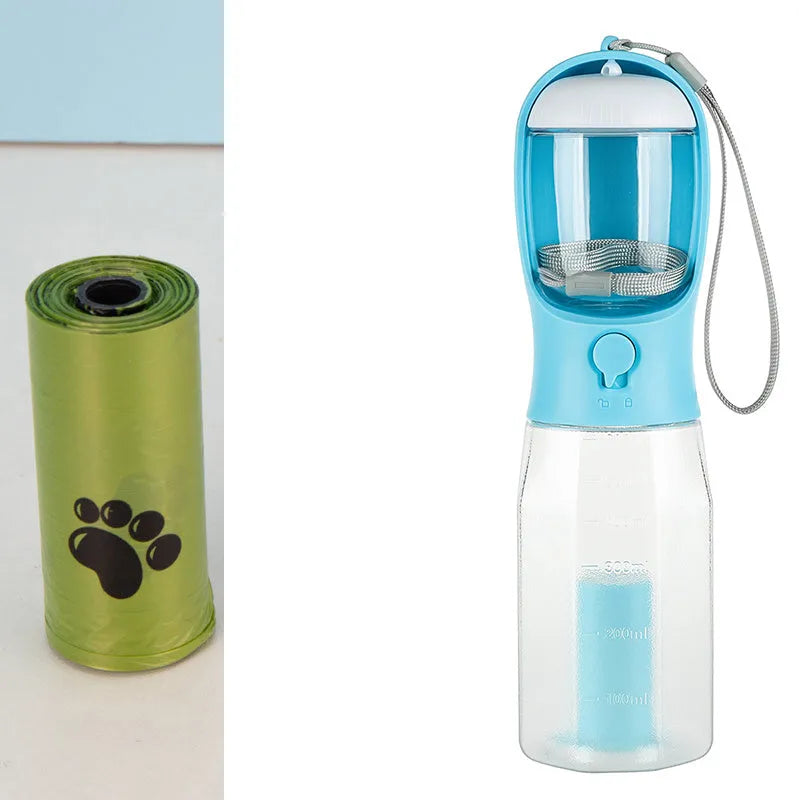Turquoise portable 3-in-1 dog water bottle with food feeder and built-in poop bag dispenser on a walk