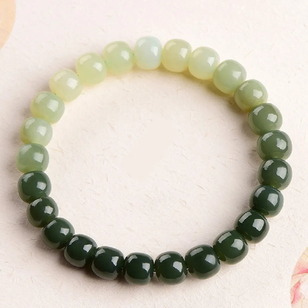 Natural Hetian jade bracelet with gradient clear water colours on wrist.