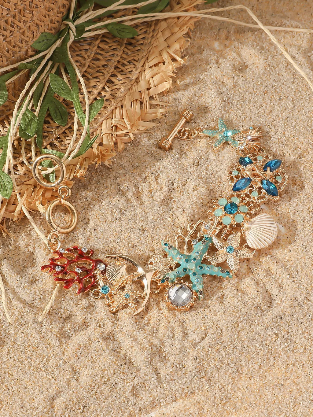 Women's alloy nautical bracelet with boat anchor and starfish charms in coral blue, red, or turquoise.