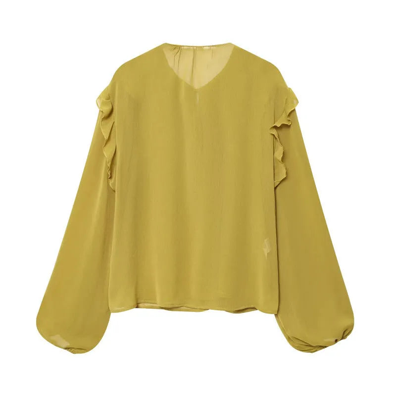 Women's ruffled laminated decorative shirt in yellow with plant and flower print, long sleeves, and button detail