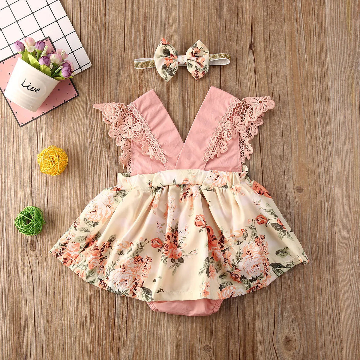 Baby girl pink floral lace V neck sleeveless jumpsuit with matching headband on white background