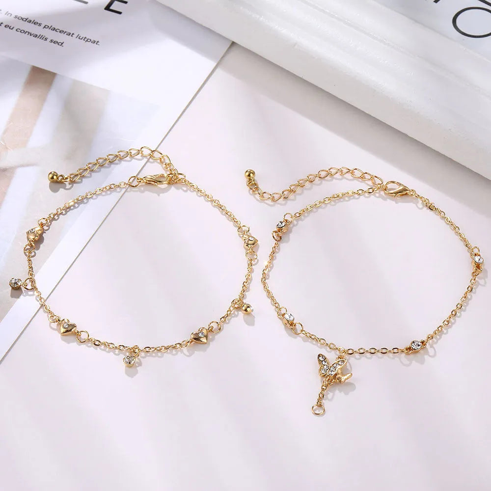 Alloy anklet with fruit-themed design and crystal inlay on a neutral background