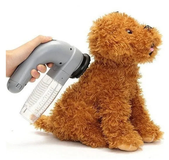 Grey portable electric pet hair remover vacuum with soft rubber grooming head for dogs and cats.