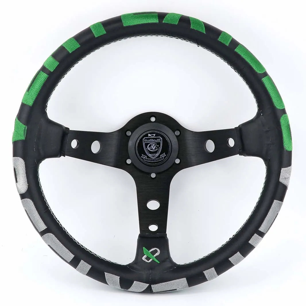 Black alloy racing steering wheel with deep concave rim and star embroidery pattern.