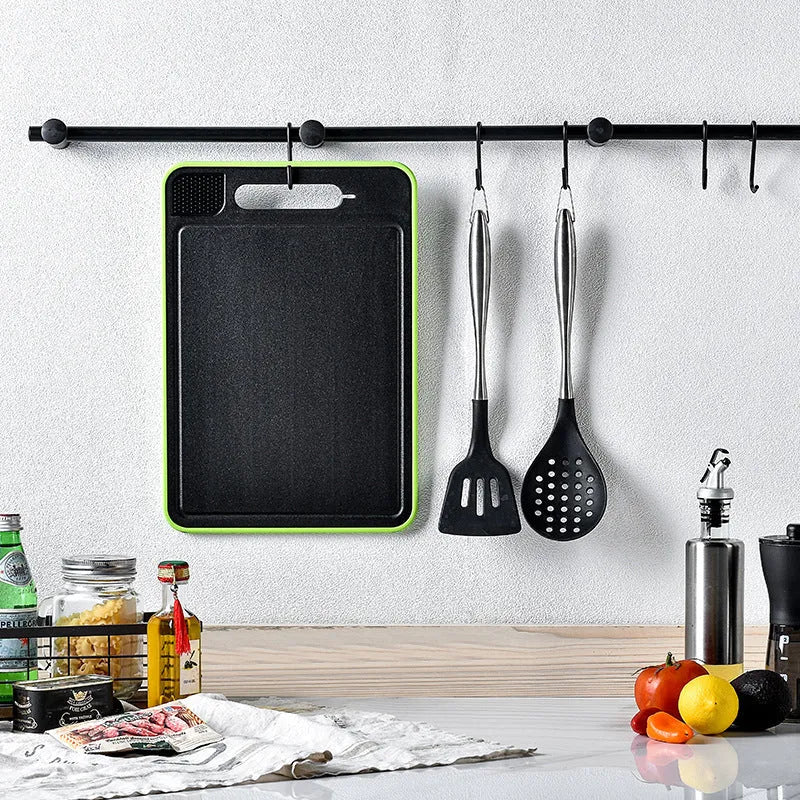 Grey square aluminium cutting board with double sides showing grinding teeth and built-in knife sharpener